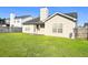 A well-maintained backyard featuring a grassy lawn, partial fence, and exterior access to the home at 286 Westbrooke Rd, Summerville, SC 29486