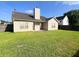 Enjoy a beautiful backyard with lush green grass, a partial fence, and rear home access at 286 Westbrooke Rd, Summerville, SC 29486