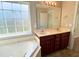 Bathroom featuring double vanity, a soaking tub, and a tiled floor at 286 Westbrooke Rd, Summerville, SC 29486