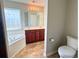 Bathroom featuring double vanity, a soaking tub, and a tiled floor at 286 Westbrooke Rd, Summerville, SC 29486