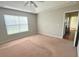 A bright bedroom features a ceiling fan and large window for natural light at 286 Westbrooke Rd, Summerville, SC 29486