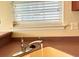 A well-lit kitchen sink features a chrome faucet and double hung window at 286 Westbrooke Rd, Summerville, SC 29486