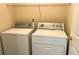 Laundry room with a white washer and dryer and wire shelving for storage at 286 Westbrooke Rd, Summerville, SC 29486
