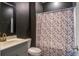 Stylish bathroom with a gray vanity, gold fixtures, and a patterned shower curtain for a modern touch at 309 Squire Pope Rd Rd, Summerville, SC 29486