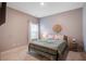 Cozy bedroom with a metal bed frame, soft bedding, a side table, and ample natural light from the window at 309 Squire Pope Rd Rd, Summerville, SC 29486