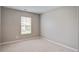 Bright bedroom features neutral walls, plush carpet, and natural light from the window at 309 Squire Pope Rd Rd, Summerville, SC 29486
