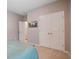 Bright bedroom featuring closet doors, neutral wall paint, and a bed covered in blue linens at 309 Squire Pope Rd Rd, Summerville, SC 29486