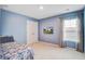 A bedroom features blue walls, carpet, TV and closet at 309 Squire Pope Rd Rd, Summerville, SC 29486