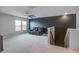 Loft-style bonus room featuring plush carpeting, a dark accent wall, a ceiling fan, and comfortable seating at 309 Squire Pope Rd Rd, Summerville, SC 29486