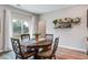 Cozy dining area featuring a round table, four chairs, a window with natural light, and decorative shelving with plants at 309 Squire Pope Rd Rd, Summerville, SC 29486