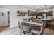 Charming dining area open to the kitchen, featuring a round table, upholstered chairs, and decorative plant shelves at 309 Squire Pope Rd Rd, Summerville, SC 29486
