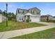 Inviting two-story home with a well-kept lawn and attached garage at 309 Squire Pope Rd Rd, Summerville, SC 29486