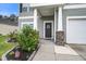 Inviting entryway with a gray front door, decorative wreath, and charming landscaping at 309 Squire Pope Rd Rd, Summerville, SC 29486