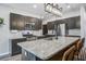 Modern kitchen features dark cabinets, stainless steel appliances, granite countertops, and a central island with bar seating at 309 Squire Pope Rd Rd, Summerville, SC 29486