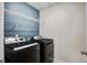 Functional laundry room with modern black washer and dryer set and wire shelving for storage at 309 Squire Pope Rd Rd, Summerville, SC 29486