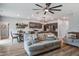 Open-concept living room showcasing modern furnishings, a ceiling fan, and an adjacent kitchen area with sleek cabinetry at 309 Squire Pope Rd Rd, Summerville, SC 29486