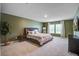 Large main bedroom with green walls, plush carpeting, and natural light from bright windows at 309 Squire Pope Rd Rd, Summerville, SC 29486
