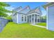 Exterior backyard view showing a screened in porch and lush green lawn at 310 Marchman St, Summerville, SC 29486