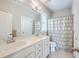 Bright bathroom featuring a double vanity with modern fixtures and a shower-tub combo at 310 Marchman St, Summerville, SC 29486