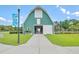 Community barn is inviting with its green exterior, white doors, well-manicured lawn and sidewalk leading to the entrance at 310 Marchman St, Summerville, SC 29486