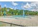 Large community pool surrounded by chairs and shade trees for recreation at 310 Marchman St, Summerville, SC 29486
