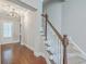 Welcoming foyer with gleaming hardwood floors and carpeted stairs leading to the upper level at 310 Marchman St, Summerville, SC 29486
