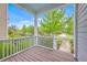 Covered front porch view showcasing neighborhood street lined with trees and sidewalks at 310 Marchman St, Summerville, SC 29486