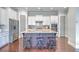Open kitchen featuring an island with barstool seating and stainless steel refrigerator at 310 Marchman St, Summerville, SC 29486