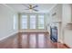 Comfortable living room boasts hardwood floors, fireplace and windows for lots of natural light at 310 Marchman St, Summerville, SC 29486