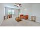 Open living room featuring a cozy seating area and functional workspace, with a ceiling fan at 310 Marchman St, Summerville, SC 29486