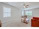 Bright living room with a ceiling fan, neutral carpet, and large windows at 310 Marchman St, Summerville, SC 29486