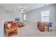 Cozy living room with neutral carpet, ceiling fan, and bright natural light at 310 Marchman St, Summerville, SC 29486