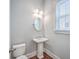 Powder room featuring pedestal sink, window and hardwood floors at 310 Marchman St, Summerville, SC 29486