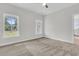 Cozy bedroom features plush carpeting and large windows, creating a comfortable and inviting retreat at 3222 Pinewood Dr, Ladson, SC 29456