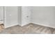 Carpeted bedroom with neutral walls and trim, featuring a double closet and access to another room at 3222 Pinewood Dr, Ladson, SC 29456