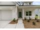 Close-up of home's entrance features a teal front door, neat landscaping, and an attached garage at 3222 Pinewood Dr, Ladson, SC 29456
