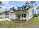 Inviting one-story home with white siding, black roof, manicured lawn, and an attached garage at 3222 Pinewood Dr, Ladson, SC 29456