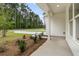 Inviting front porch with lush landscaping, ideal for relaxation and enjoying the outdoors at 3222 Pinewood Dr, Ladson, SC 29456