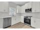 Bright kitchen with stainless steel appliances, white cabinets, and light countertops offers a modern and clean aesthetic at 3222 Pinewood Dr, Ladson, SC 29456