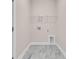 Functional laundry room with tile flooring, utility connections, and overhead shelving at 3222 Pinewood Dr, Ladson, SC 29456