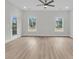 Bright and airy living room featuring large windows and a ceiling fan, perfect for relaxing or entertaining at 3222 Pinewood Dr, Ladson, SC 29456