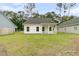 Rear exterior of home with a well-kept lawn, a covered porch, and tasteful exterior colors at 3222 Pinewood Dr, Ladson, SC 29456