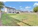View of the big backyard with a wood fence, grass and two-story house at 340 Albrighton Way, Moncks Corner, SC 29461