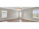 Bright bedroom with three windows, hardwood floors, and ceiling fan at 340 Albrighton Way, Moncks Corner, SC 29461
