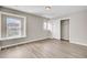 Bright bedroom featuring neutral walls, wood-look flooring, and closet with white doors at 340 Albrighton Way, Moncks Corner, SC 29461