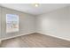 Bedroom features a window with blinds, hardwood floors, and neutral colored walls at 340 Albrighton Way, Moncks Corner, SC 29461