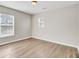 This bedroom is sun-filled and features neutral walls, wood-look flooring, and two windows at 340 Albrighton Way, Moncks Corner, SC 29461