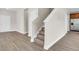 Entryway features hardwood floors, stairs with white banister, and a view of the kitchen at 340 Albrighton Way, Moncks Corner, SC 29461