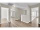 Upstairs hallway showing hardwood floors and views into multiple bedrooms at 340 Albrighton Way, Moncks Corner, SC 29461