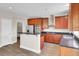 Spacious kitchen features stainless steel appliances, wood cabinets, and a center island with black countertops at 340 Albrighton Way, Moncks Corner, SC 29461